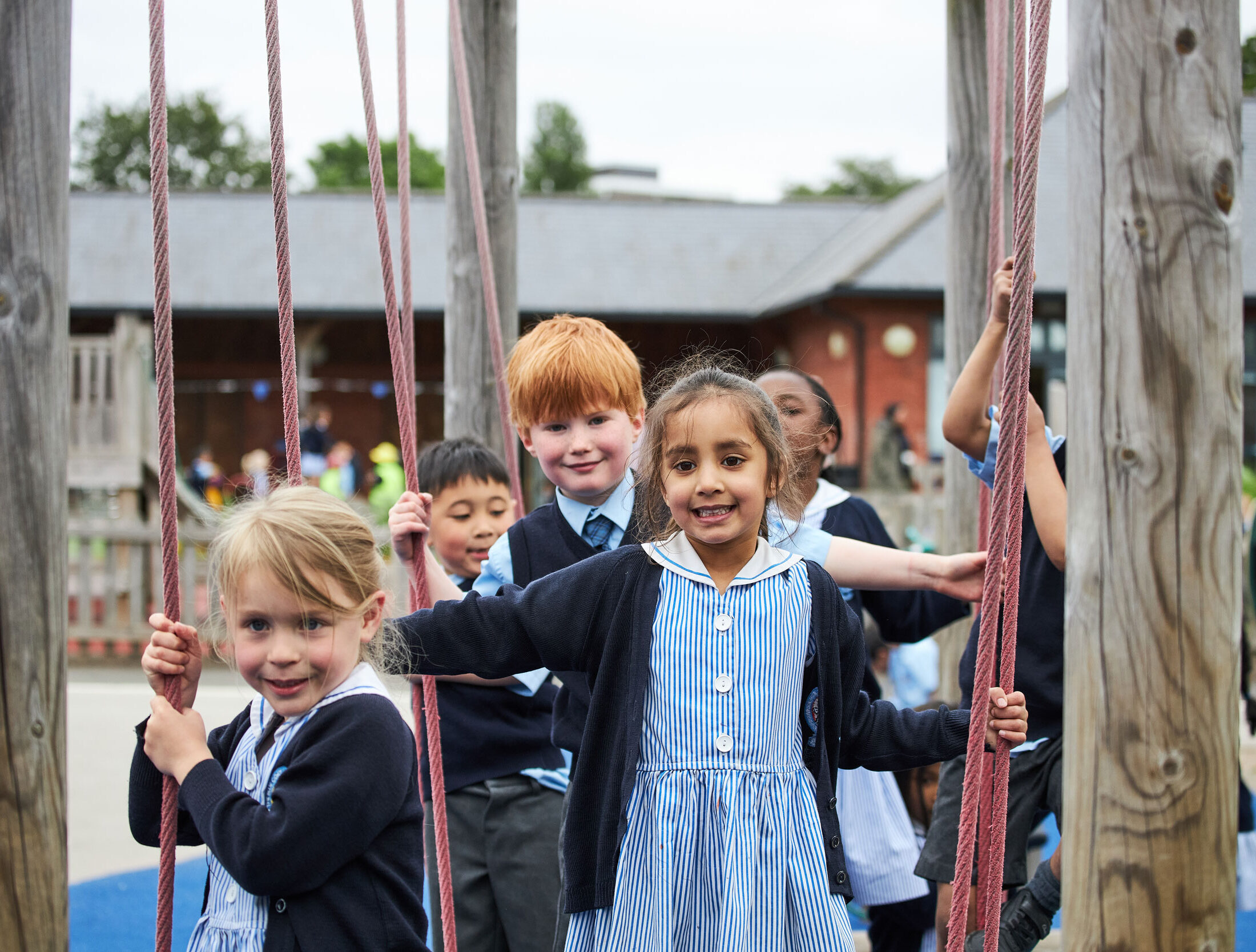 Five Pre-Prep children playing on the adventure trail playground at The Blue Coat School.