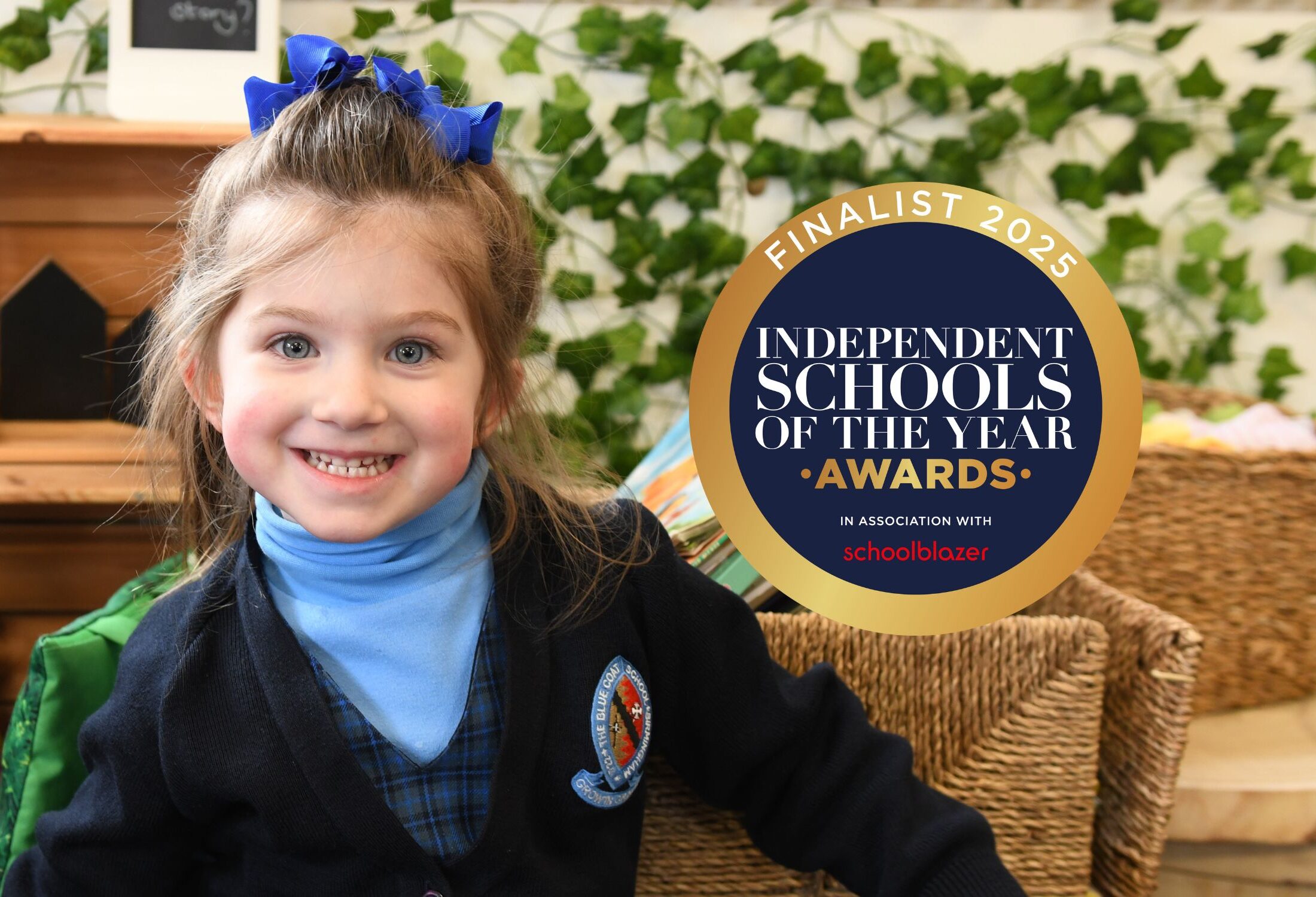 A girl in Blue Coat School Birmingham uniform smiling at the camera next to a badge celebrating being a Finalist for the Prep School of the Year.