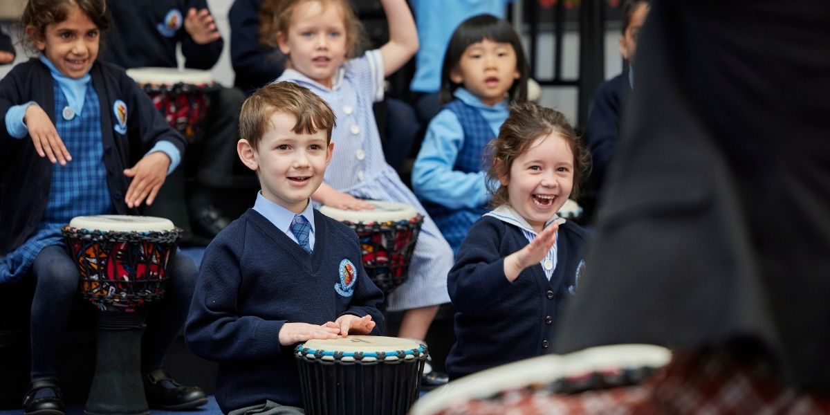 A class of Pre-Prep children are having a drumming lesson.