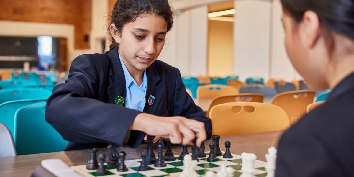 A girl playing chess at The Blue Coat School Birmingham